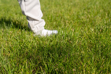 Child wearing socks outside walking in grass causing stains.