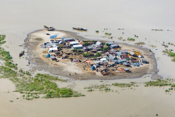 Aerial view showcasing the devastating impact of floods on villages in Northern Bangladesh, highlighting the submerged homes, affected communities, highlighting the severe impact and the resilience