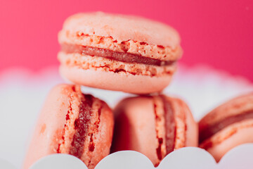  Macaron cakes set.white cardboard box filled with pink macarons set against a pink backdrop.French pastries set. macarons close-up background.Assorted sweet pastries. 