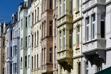 beautifully restored pastel-colored old buildings with bay windows from the founder's era in the...