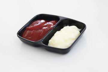 Tomato sauce in small bowl on tile background