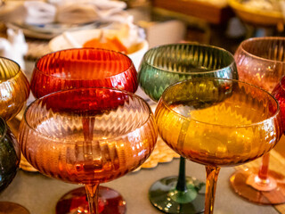 Colorful Glassware in a Vintage Goods store are lined up neatly on display. High quality photo