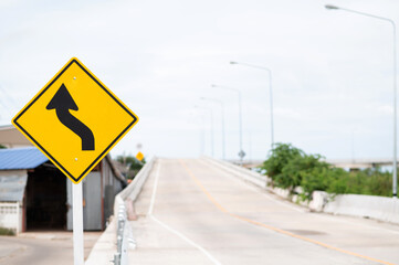 Selective focus on Left curve warning sign.Background is U-turn road. 