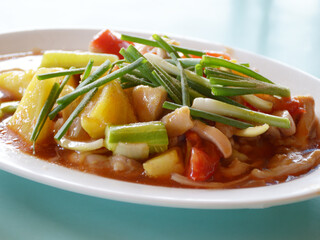 close up fried pork with pineapple tomato onion and sweet sauce