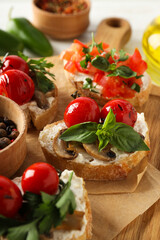 Sandwiches with grilled vegetables on a board, on a green background.
