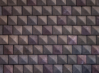 Square Cube Brick Wall with Rose, Tan, and Grey Bricks.