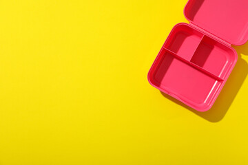 Pink lunch box on a yellow background