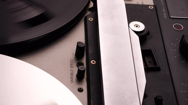 Rolling Reel to Reel Audio Tape in Professional Magnetophone Recorder, Close Up