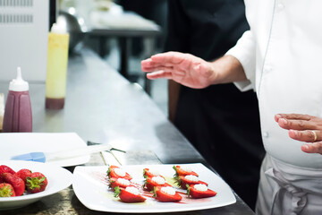 Unrecognizable Professional Chef Preparing Strawberry Dessert