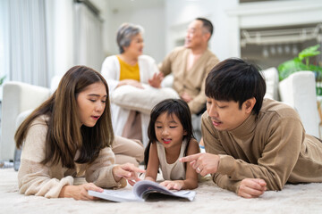 Fototapeta premium Portrait happy love asian family mother teach little daughter asian girl learn and study on table.Mom and asian young girl read with book and pencil making lessons in homeschool at home.Education