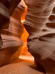 Antelope Canyon in Arizona showcases stunning sandstone formations with narrow passageways illuminated by beams of light, creating a breathtaking and photogenic natural wonder perfect for exploration 