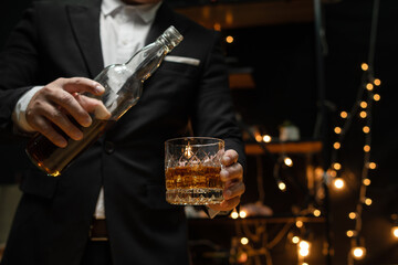 Barman pouring whiskey whiskey glass beautiful night