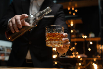 Barman pouring whiskey whiskey glass beautiful night