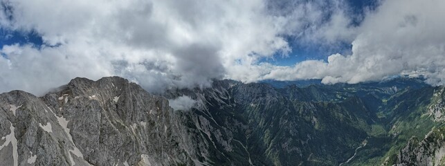  A stunning aerial view of Logarska Dolina in Slovenia, showcasing its breathtaking alpine valley, lush greenery, and the serene beauty of the Kamnik-Savinja Alps © Semi
