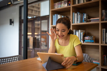 Young woman having video call via computer in the home office.Business video conferencing.