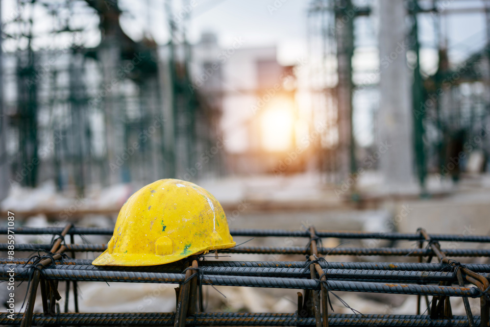 Wall mural Yellow and white helmets for worker on the Steel frame in factory construction site, contractor, real estate business, safety first concept.