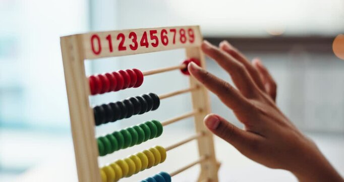 Math, child and hand on desk, abacus beads and closeup of education and student in middle school. Classroom, studying and practice for exam of counting, growth and development of kid on table