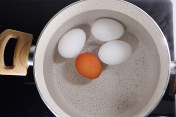 Boiled eggs in a saucepan on ceramic hob