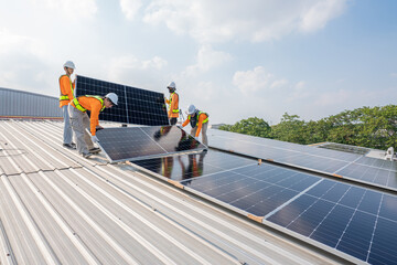 Men technicians carrying photovoltaic solar moduls on roof of factory on the morning. Installing a Solar Cell on a Roof. Solar panels on roof. Workers installing solar cell power plant eco technology.