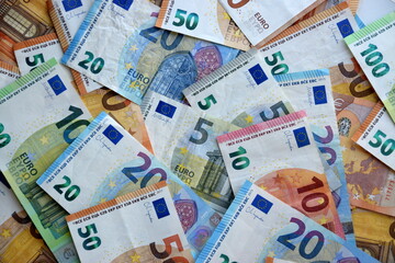 Many european euro money bills in chaotic arrangement. Pile of eur banknotes with different colors and condition