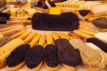 Various types of household and hair brushes with natural bristles.