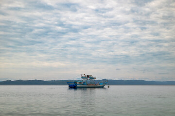 A fishing boat is anchored on the beach