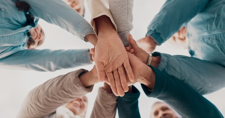 Obraz premium Huddle, hands and group of people together with agreement and celebration for solidarity in community circle. Family, trust and teamwork with cooperation for bonding, love and outdoor in low angle