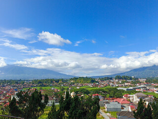  Landscape view of clouds between mountains taken from the top of a hill and showing views of the city