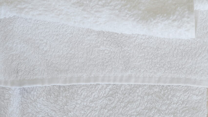 White and beige towels neatly stacked, adding a touch of elegance and comfort.