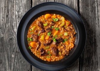 beef barley soup in a bowl, top view