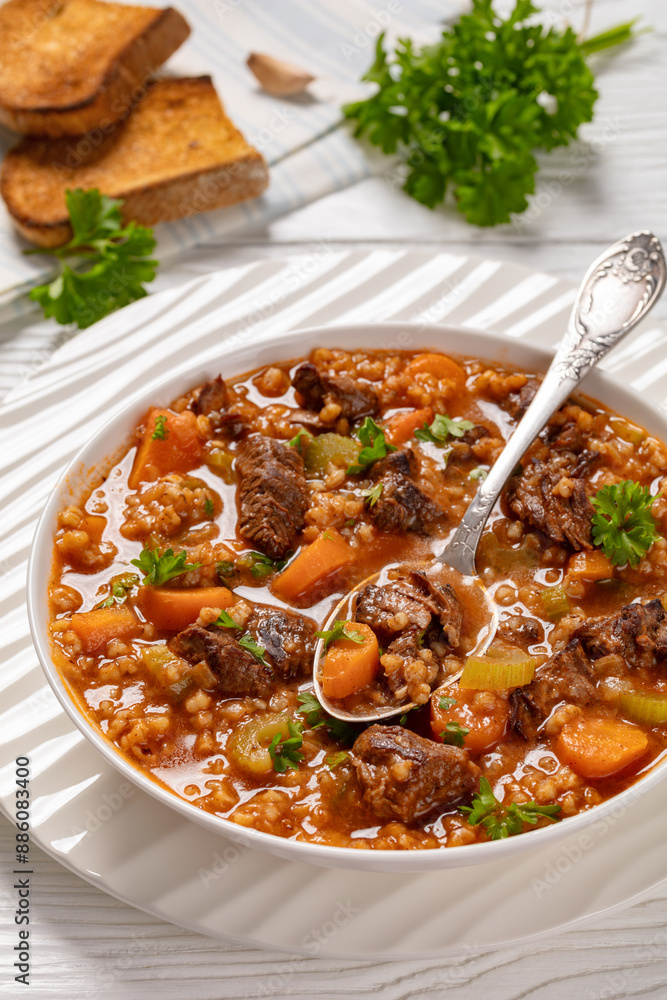 Wall mural beef barley soup in a bowl, top view