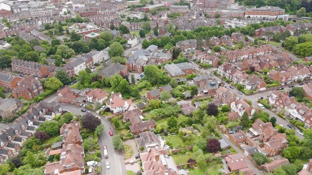 Aerial view of charming red brick suburbs, showcasing quaint residential architecture and lush greenery in Exeter, UK