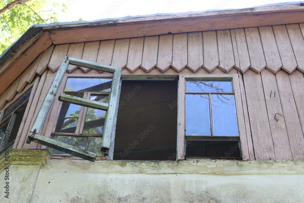 Aufkleber An open window on the side of a building offers a glimpse into its interior.