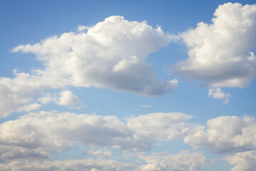 Blue sky with white clouds, shot on a sunny summer day.