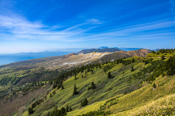 Naklejka premium The magnificent view of Mount Kusatsu-Shirane in early spring with remaining snow.
