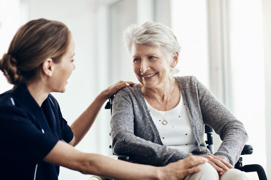 Support, nurse and senior woman in wheelchair for assistance, help or medical care in retirement home. Discussion, friendly caregiver and elderly patient with disability for wellness, health or trust