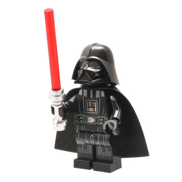 Lego minifigure of Darth Vader from Star Wars with lightning sword isolated on white. Editorial illustrative image of popular plastic constructor and 25 Anniversary.