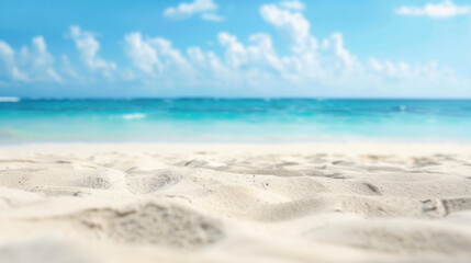 Fototapeta premium Close-up beach scene under blue sky with white clouds, featuring sand and sea horizon