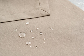 Water Droplets on Beige Fabric Surface Close Up
