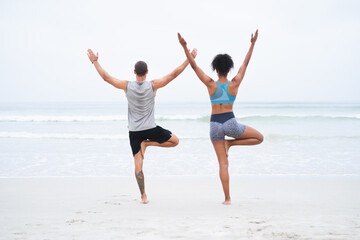 Obraz premium Couple, yoga and back with meditation, balance and wellness for mindfulness, wellbeing and health. Woman, man and beach with together, session and activity for practice, stretching and zen for peace