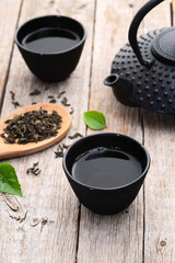 Green Tea with japanese teapot and leaves