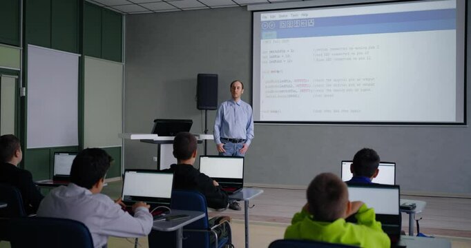 Adult Man Teaching Schoolers To Programming And Coding, Teens Boys Listening To Him, Optional Class
