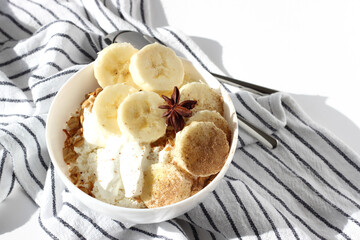 Breakfast Bowl of Greek Yogurt, Cottage Cheese, Freshly Baked Granola with Banana Slices. 