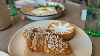 Filipino food at a brunch cafe in Chicago, ube tart and black truffle croissant and egg. Food photography. 
