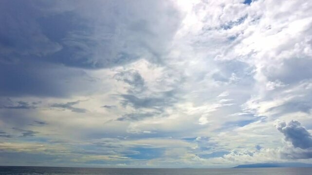Clouds moving slowly over the ocean. Timelapse on a cloudy day over the tropical oceans.
