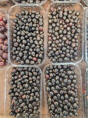 blueberries and raspberries lie on store shelves