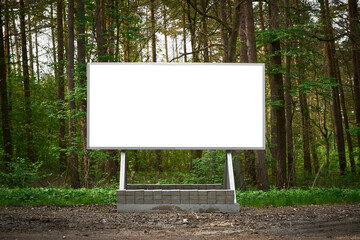 Blank billboard in lush forest offers perfect advertising space