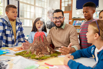 Teacher explaining volcano eruption to elementary class