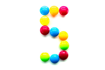 Digit 5 of multicolored rainbow candies isolated on white background. alphabet and numbers