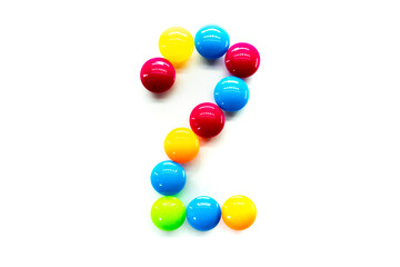 Digit 2 of multicolored rainbow candies isolated on white background. alphabet and numbers